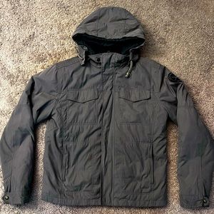 Outer shell is a military green inner shell is a dark gray